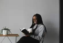 A girl sitting in the Corner and Reading Recommended Reading